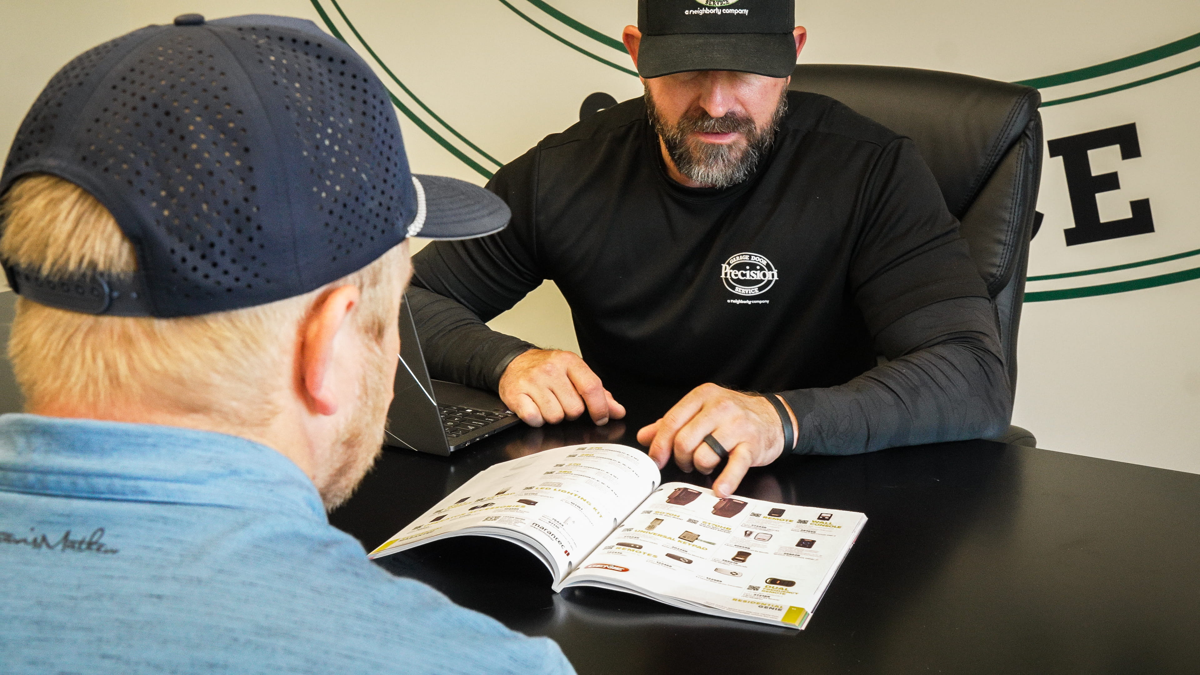 Owner Meeting with a Customer to Discuss Garage Door Opener Options