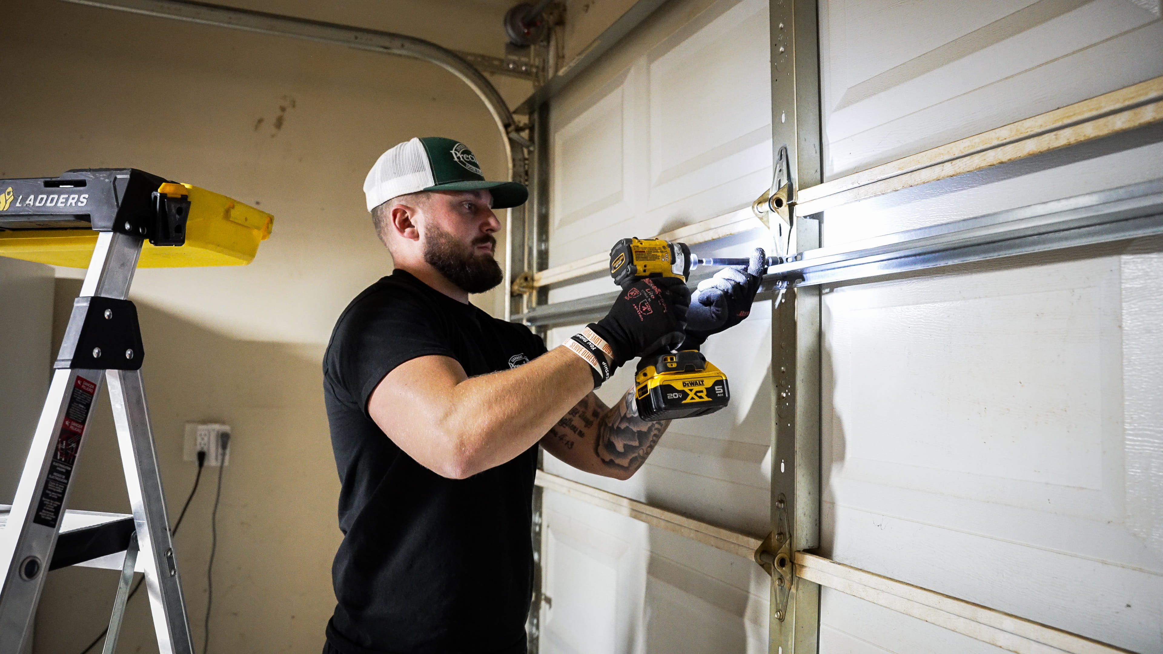 Technician Performing Garage Door Maintenance Technician Performing Garage Door Maintenance