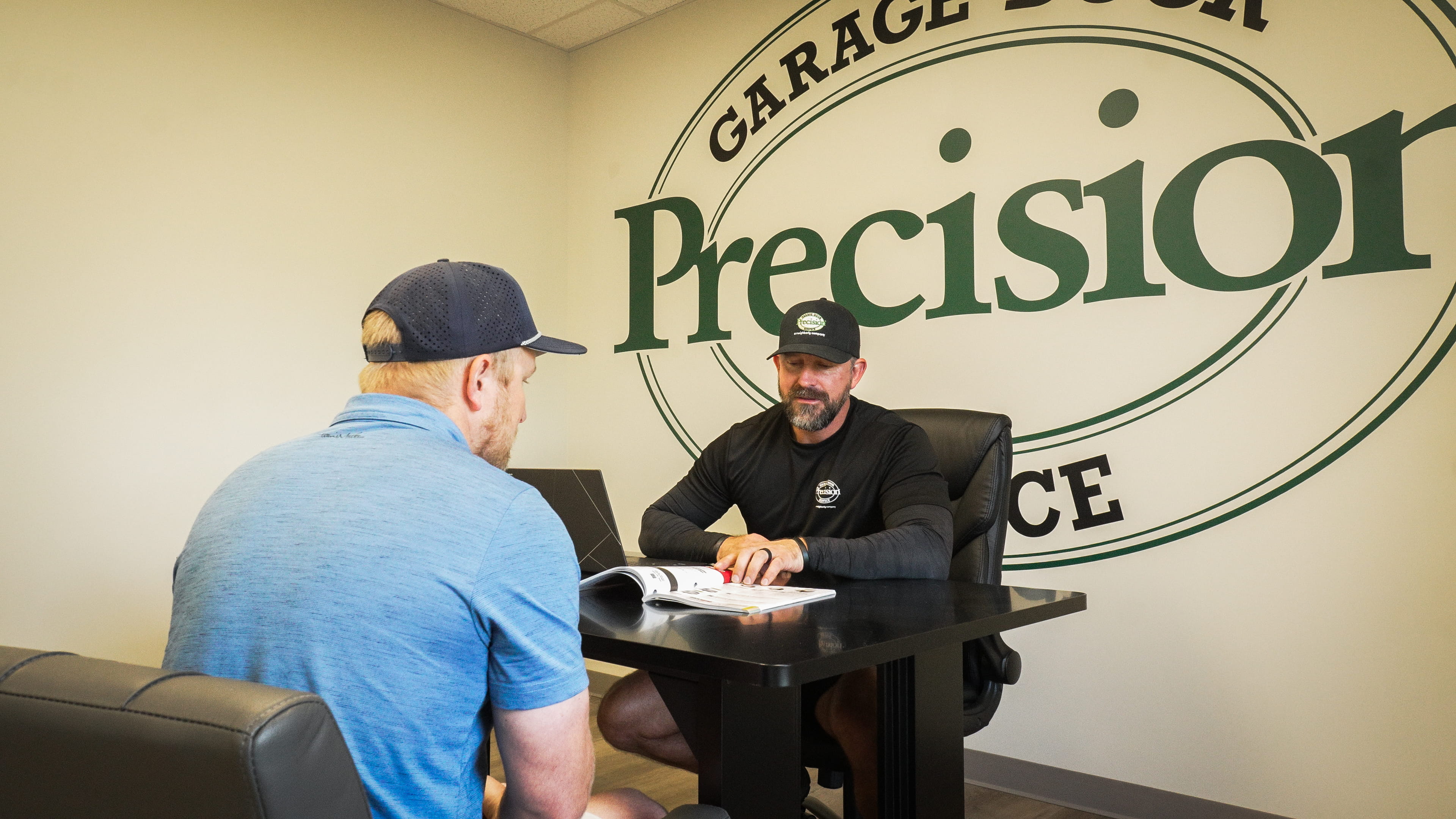 Owner Meeting with a Customer Regarding Custom Garage Door Options Owner Meeting with a Customer Regarding Custom Garage Door Options