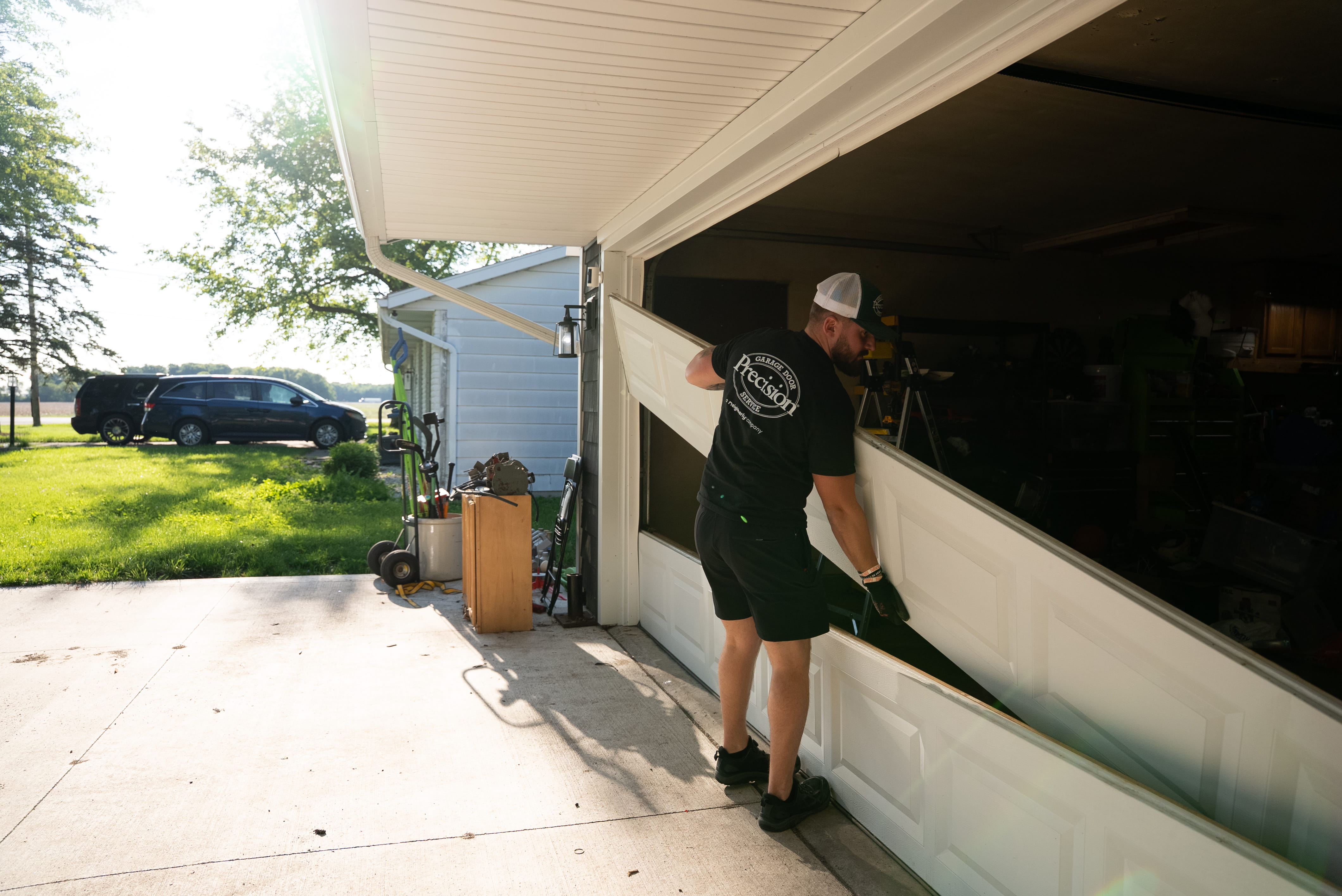 Technician Working on a New Garage Door Technician Working on a New Garage Door
