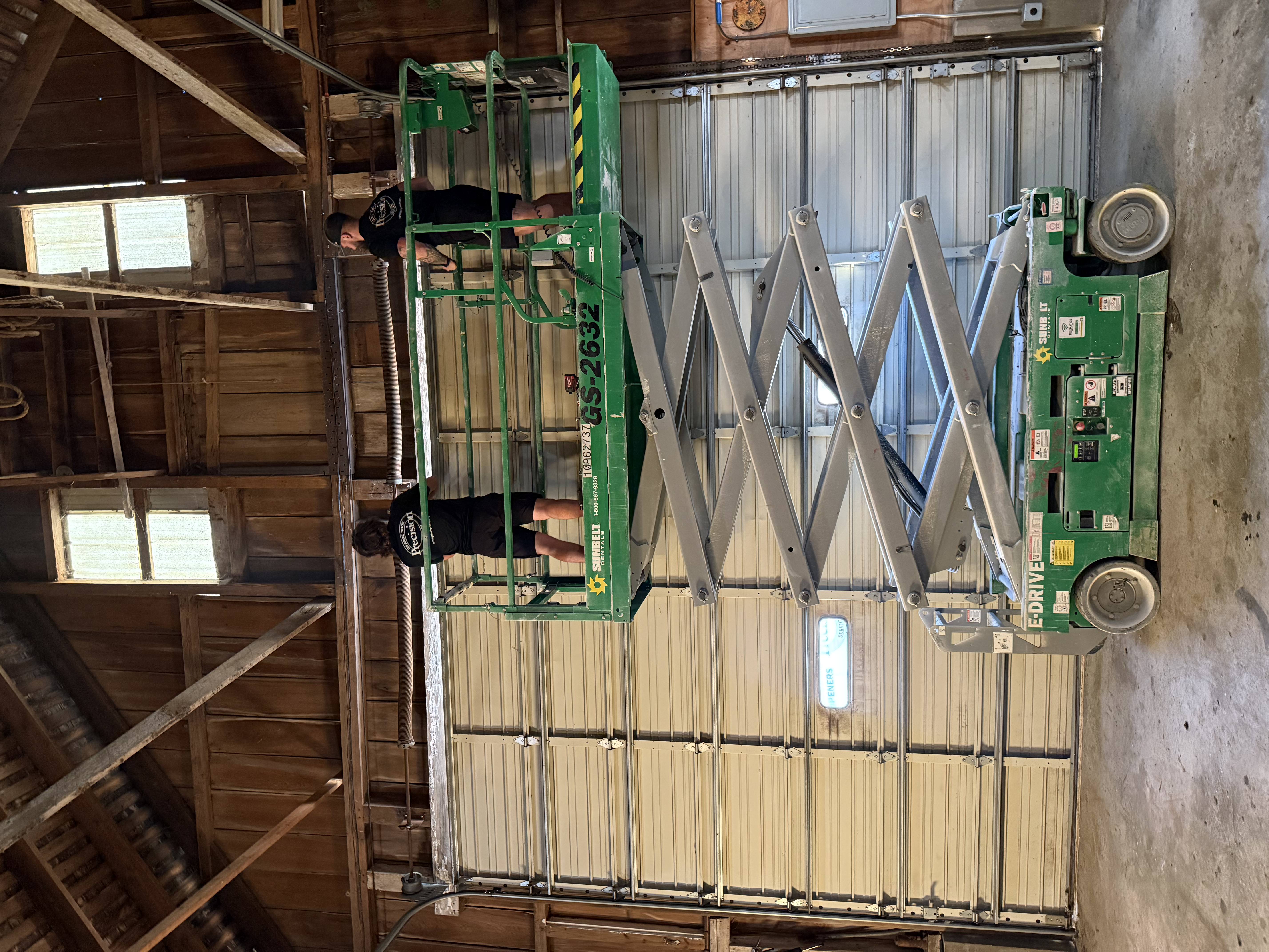 Precision Team Working on a Pole Barn Garage Door